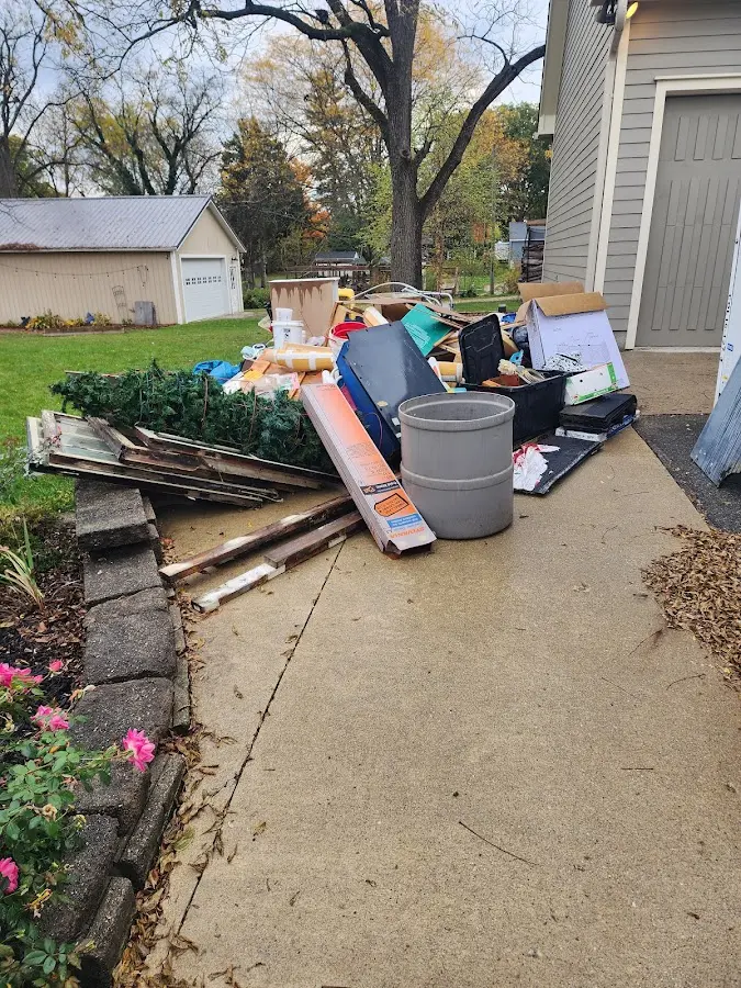 Dumpster being loaded with debris for 12 Yard Dumpster Rental in Bothell East